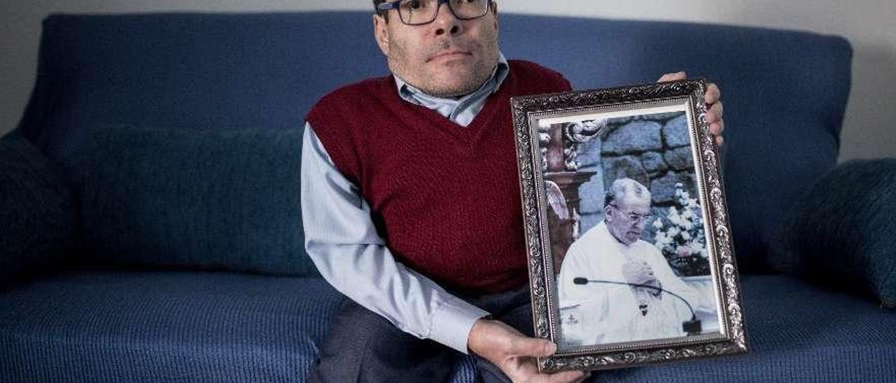 José Manuel Enríquez, con una fotografía de su tío Adolfo, víctima de un crimen en 2015. // Brais Lorenzo