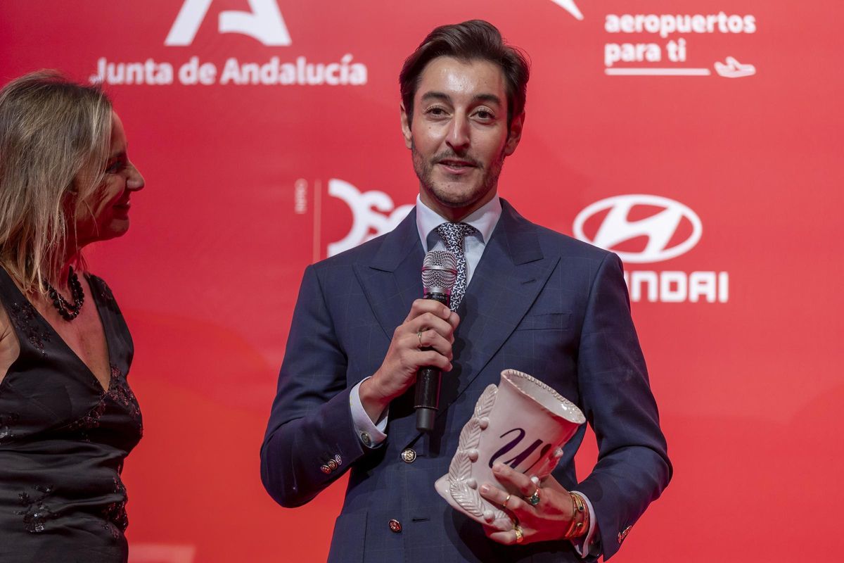 Nicolás Montenegro recibe el premio de la firma The Exvotos en los Premios Woman Andalucía.