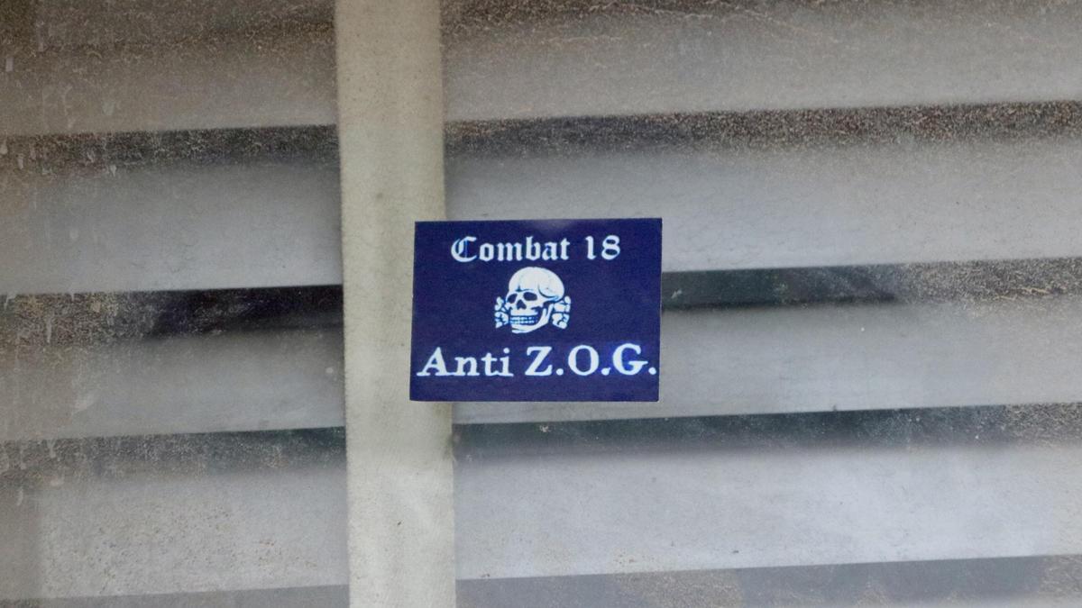 Pegatina con el nombre de Combat 18, en uno de los edificios registrados en Sentmenat.
