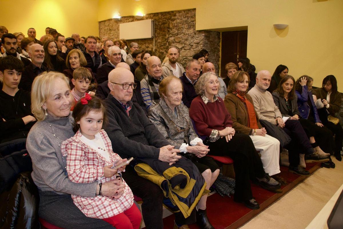 En la primera fila, Trinidad Gómez arropada por sus hijos y el público asistente al acto.