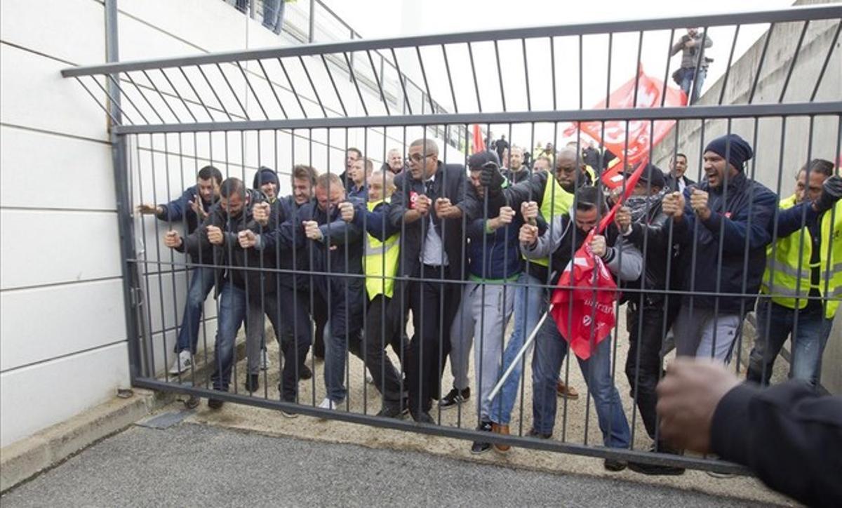 Trabajadores de Air France intentan forzar una puerta, durante la reunión que se celebraba esta mañana en el aeropuerto de Roissy, al norte de París.