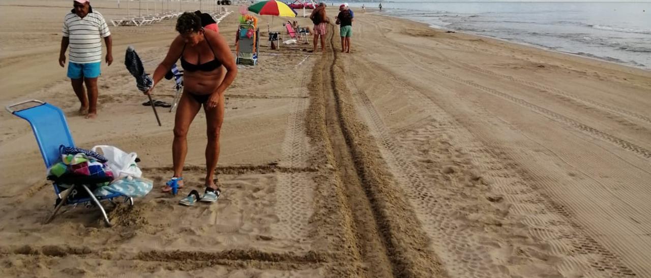 El surco que la Policía Local de Gandia crea cada día en la playa para delimitar la zona para tomar el sol