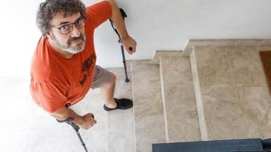 Lluís Francès subiendo las escaleras de su edificio, donde no hay ascensor.