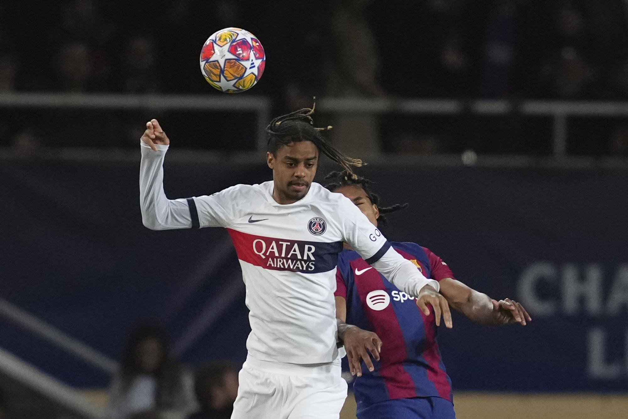 PSG's Bradley Barcola, left, jumps for the ball with Barcelona's Jules Kounde during the Champions League quarterfinal second leg soccer match between Barcelona and Paris Saint-Germain at the Olimpic Lluis Companys stadium in Barcelona, Spain, Tuesday, April 16, 2024. (AP Photo/Emilio Morenatti)