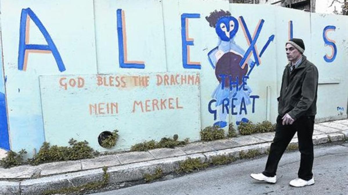 Un hombre pasa frente a una pintada en la que figura «Alexis, el grande», en relación al primer ministro, Alexis Tsipras, en Atenas.
