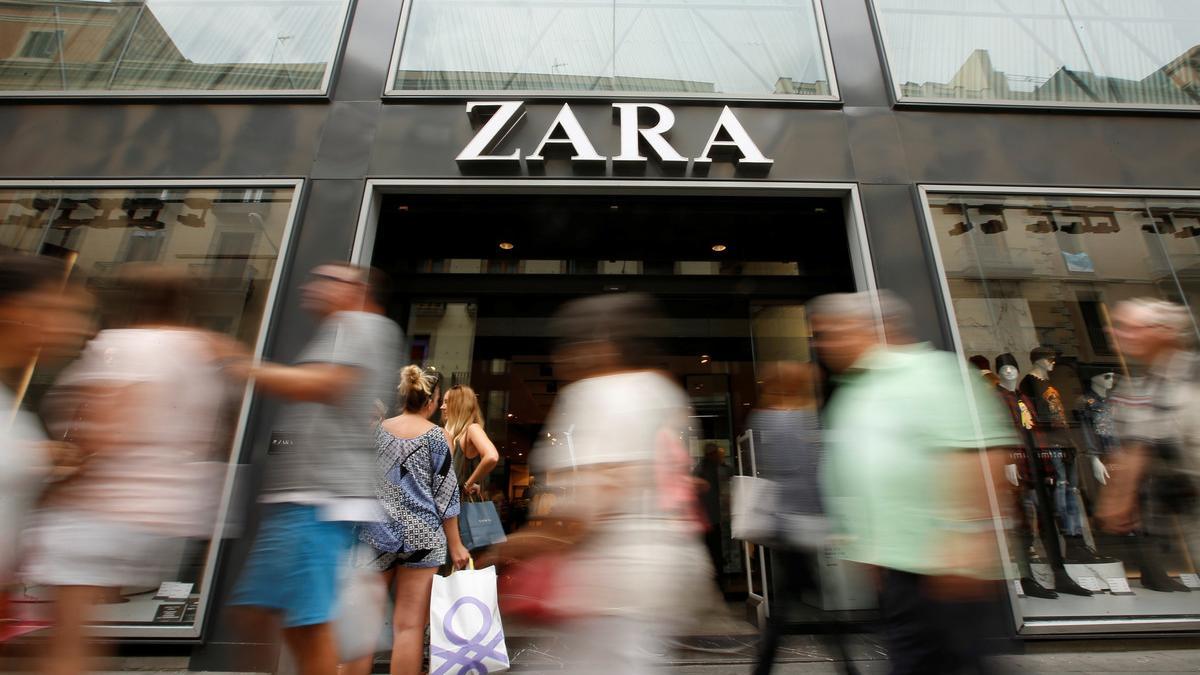 People walk past a Zara store, an Inditex brand, in central Barcelona