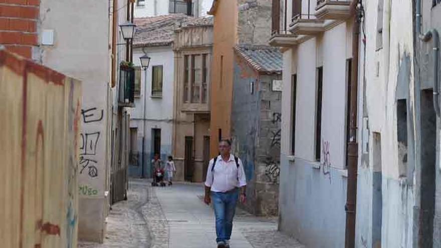 Un viandante camina por la calle Carniceros. Foto Emilio Fraile