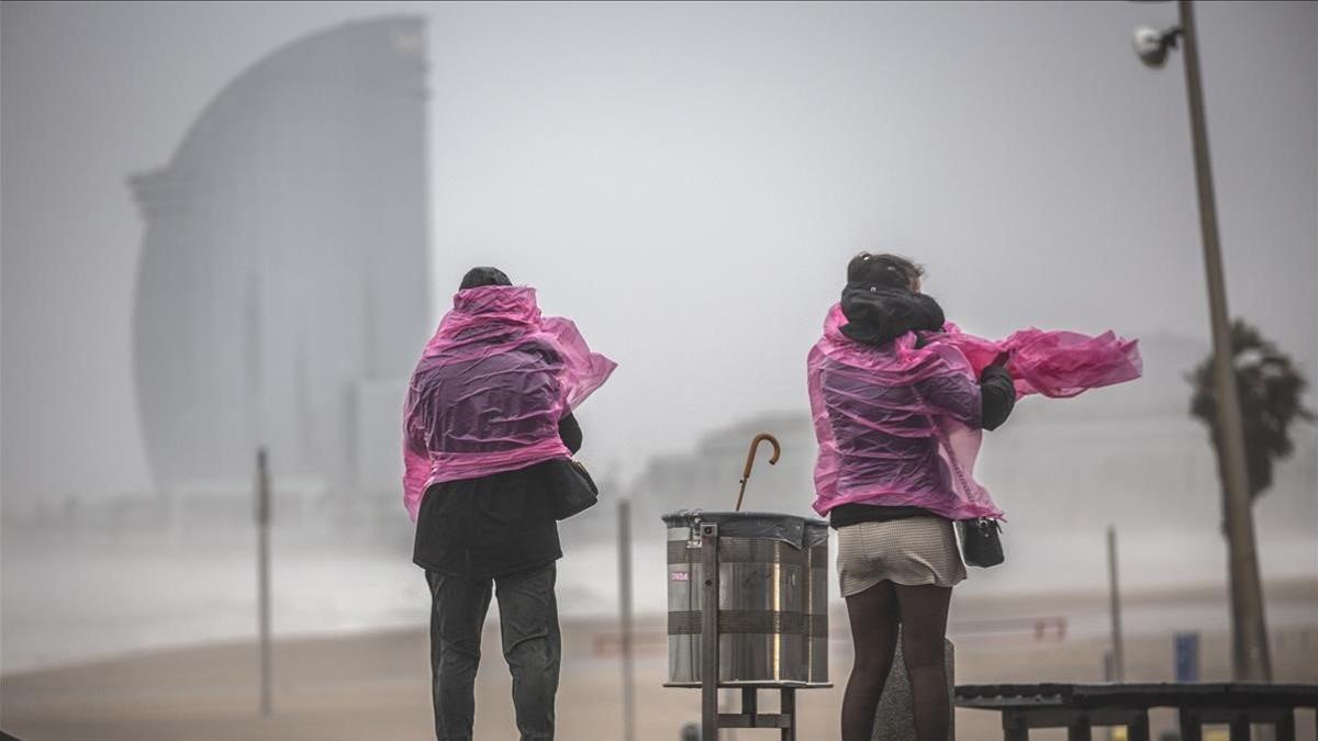 Dos mujeres, en el paseo maritimo de la playa de la Barceloneta tras la borrasca 'Gloria', el 21 de enero del 2020