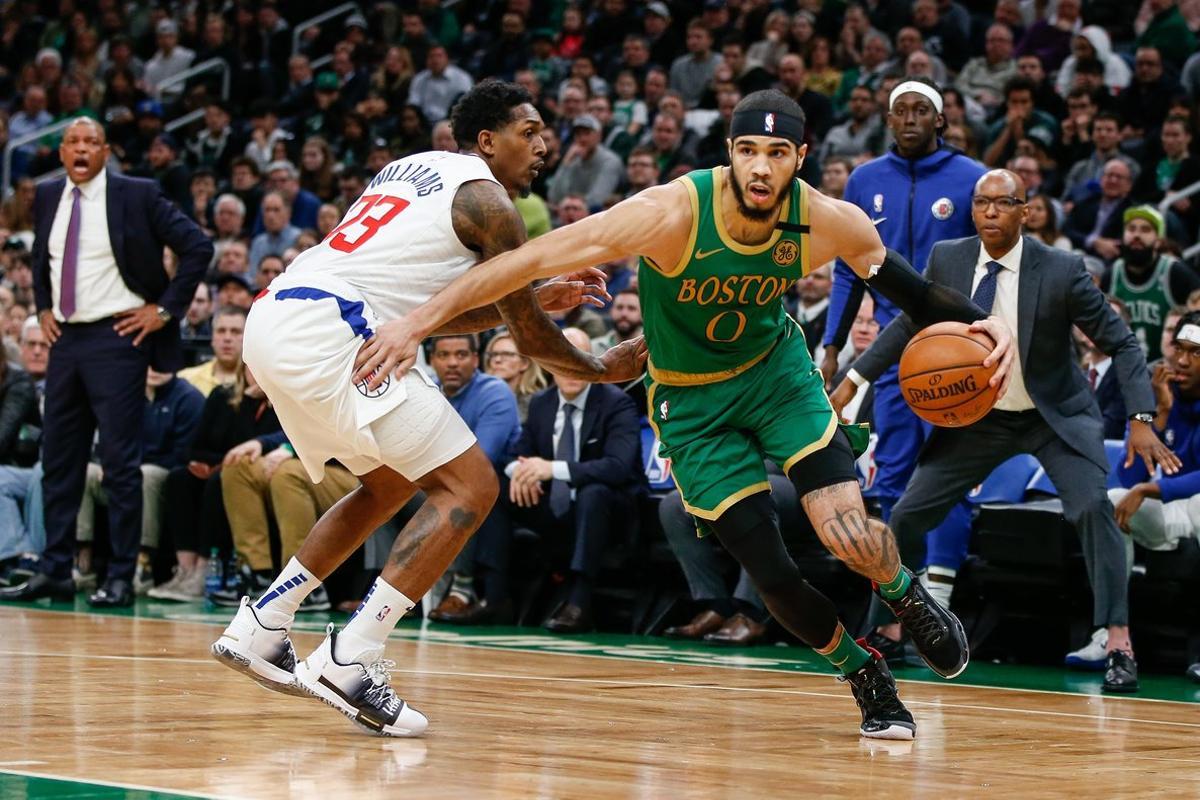 Feb 13, 2020; Boston, Massachusetts, USA; Boston Celtics forward Jayson Tatum (0) drives past Los Angeles Clippers guard Lou Williams (23) during the first overtime at TD Garden. Mandatory Credit: Greg M. Cooper-USA TODAY Sports