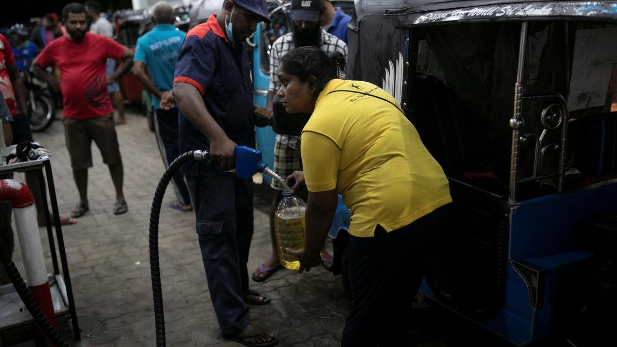 The Wider Image: Sri Lankan woman rickshaw driver has to queue 12 hours, or more, for fuel