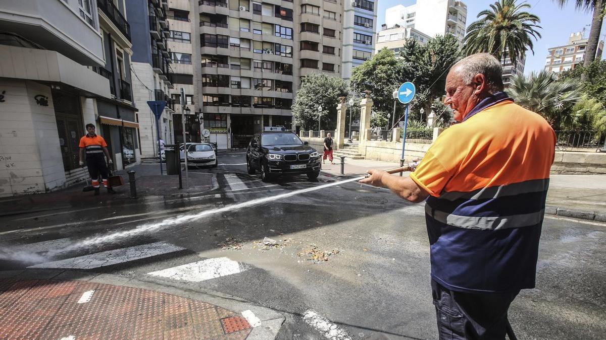 Un operario baldea una calle céntrica de Alicante, en una imagen de archivo