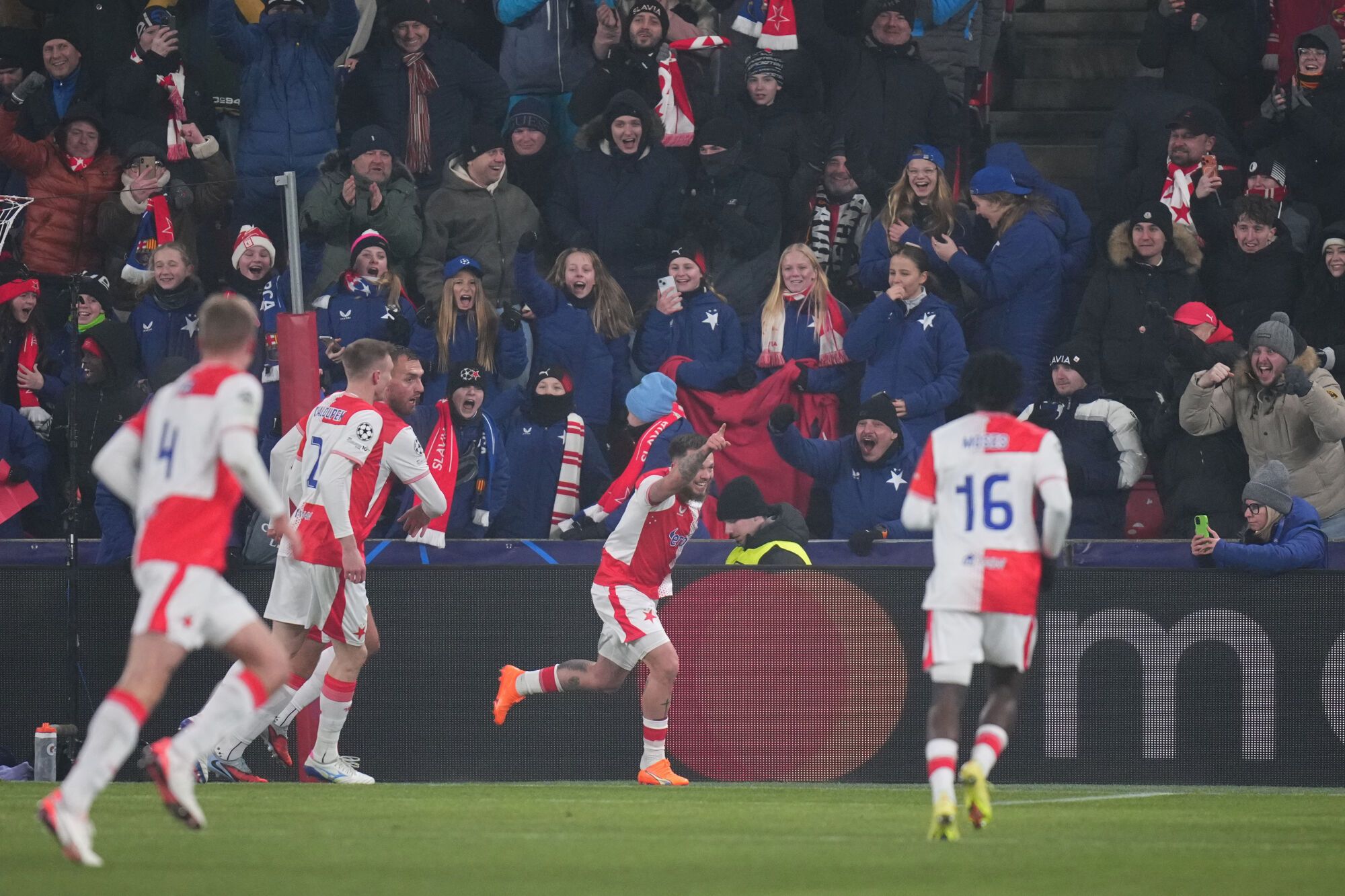 Slavia's Vasil Kusej, second right, celebrates after scoring his side's opening goal during the Champions League opening phase soccer match between Slavia Prague and Barcelona in Prague, Czech Republic, Wednesday, Jan. 21, 2026. (AP Photo/Petr David Josek)