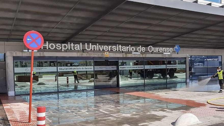 Miembros de la UME desinfectaron la entrada del nuevo edificio de hospitalización del CHUO. // C. Peteiro