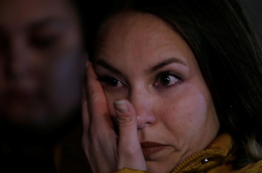 A woman cries during a vigil as a miner rescue ...
