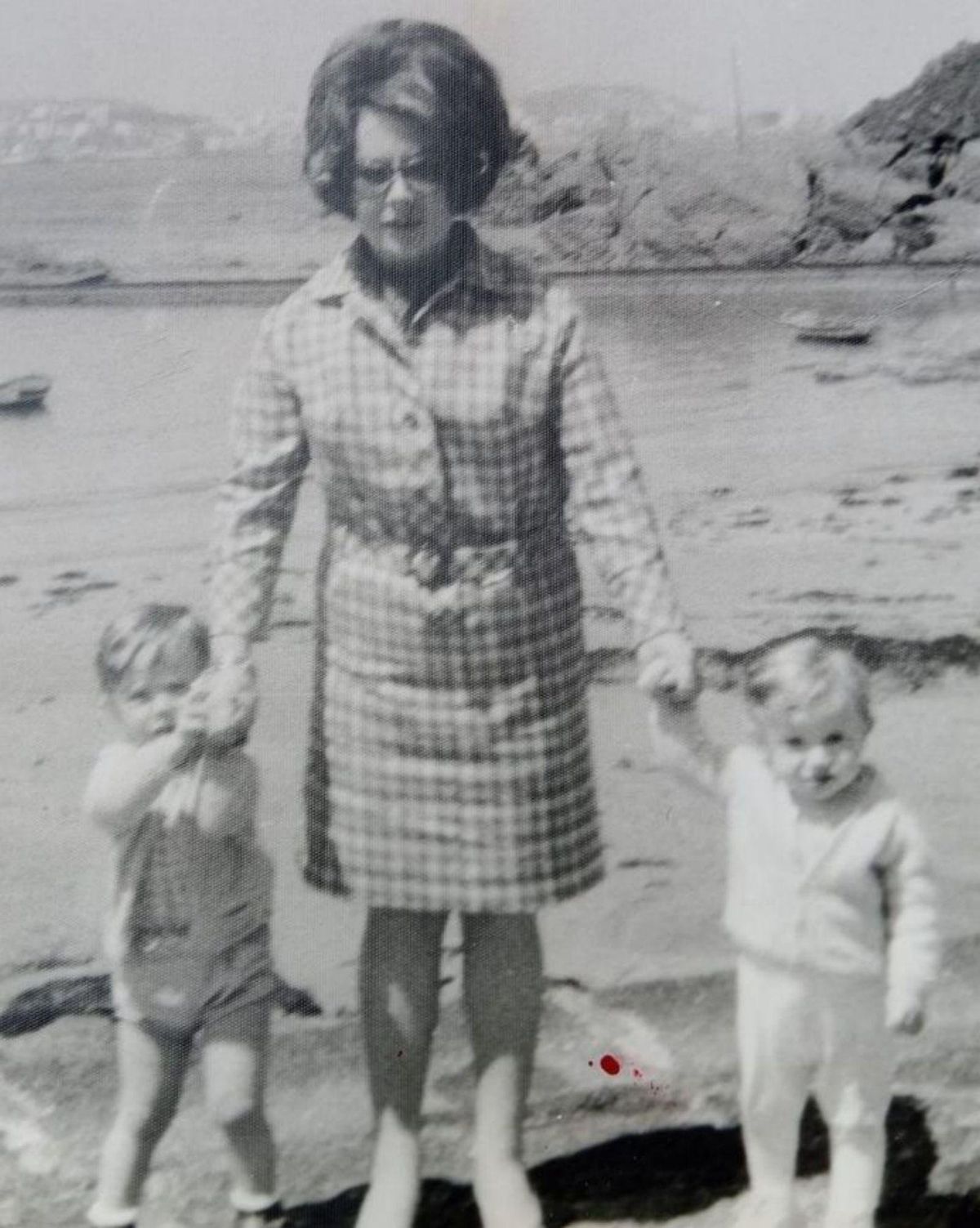 A la izquierda, María Elena en la playa de Santa Cruz con sus hijos Rafael y Juan Carlos. A la derecha, es la niña con la mano en el hombro de su abuelo José.