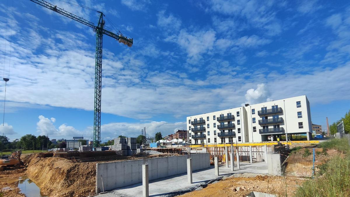Obras de cimentación del nuevo complejo residencial de Les Bellotines. Al fondo, el edificio de vivienda pública del alquiler para jóvenes.