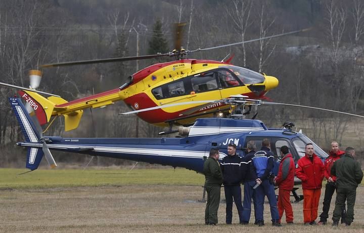 Rescue helicopters from the French Securite Civile and the Gendarmerie are seen in front of the French Alps during a rescue operation near the crash site of an Airbus A320
