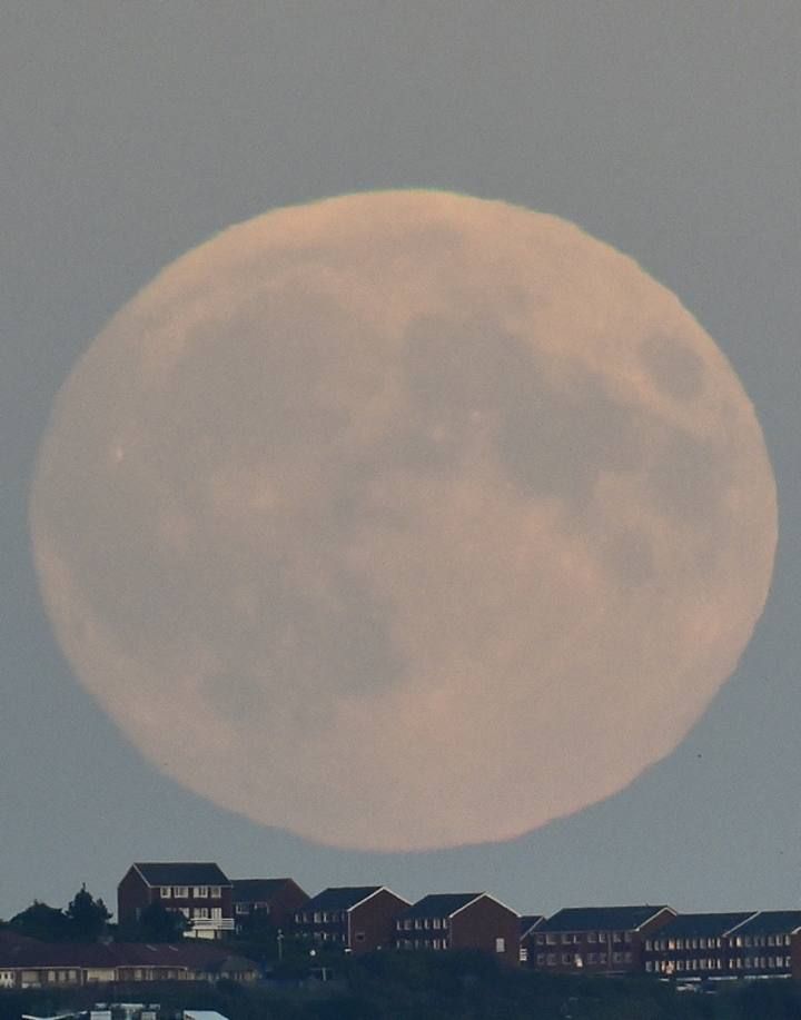A "supermoon" rises above Brighton in southern England