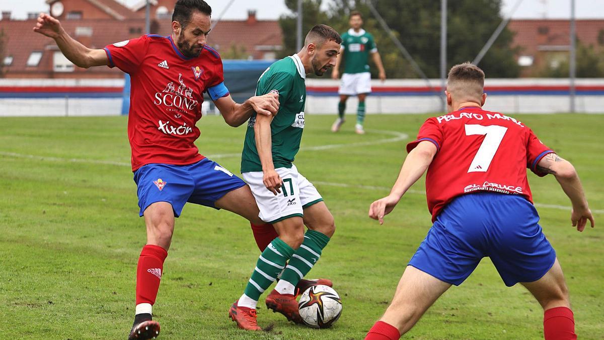 Chiqui, del Coruxo, intenta controlar el balón ante la presión de un jugador del Ceares, durante el partido de ayer. // JUAN PLAZA