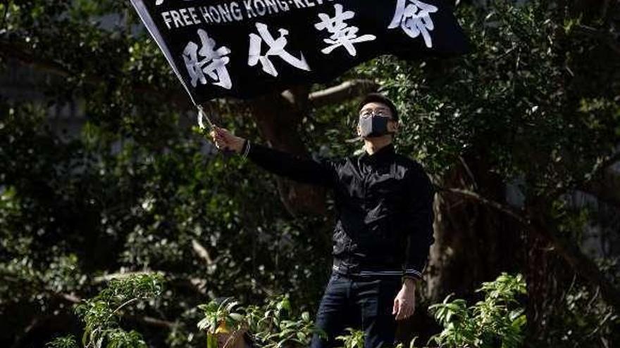 &quot;Hong Kong libre. Revolución ahora&quot; puede leerse en la pancarta agitada ayer por un manifestante en la excolonia británica. // Efe