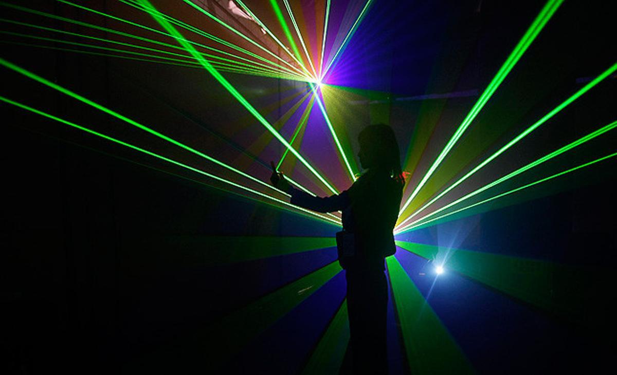 Una dona fa una fotografia amb el seu mòbil durant una exhibició a la International Optoelectrical Expo, a la província xinesa de Hubei.