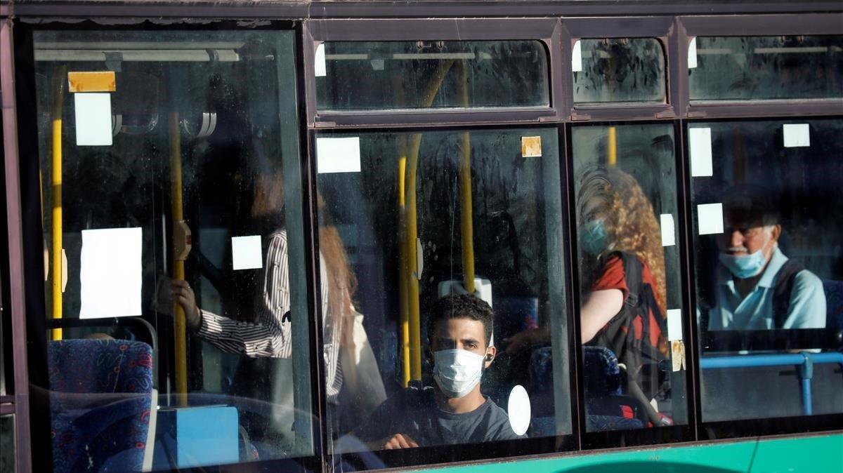 zentauroepp53835534 passengers are seen through a window as they wear masks whil200621195407