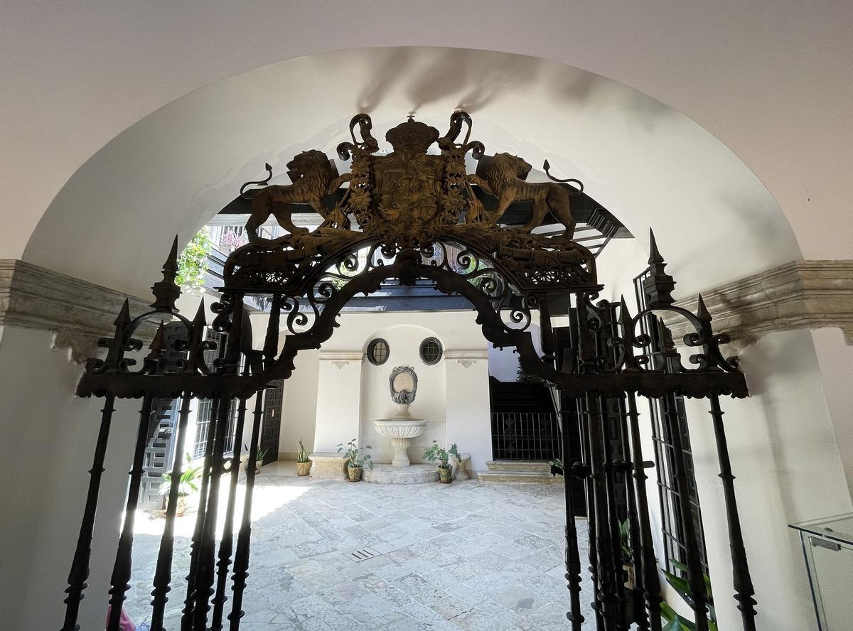 Fastuosa verja de entrada y patio de la antigua Casa del Consulado con la fuente de 1782, el primer edificio protegido de Málaga.