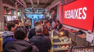 Los dependientes de una tienda de ropa con las rebajas ya activas esta semana atienden a los clientes