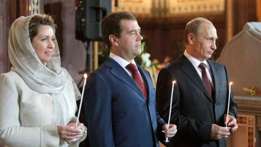 Medvédev, su esposa Svetlana y Putin, en la catedral de Moscú.