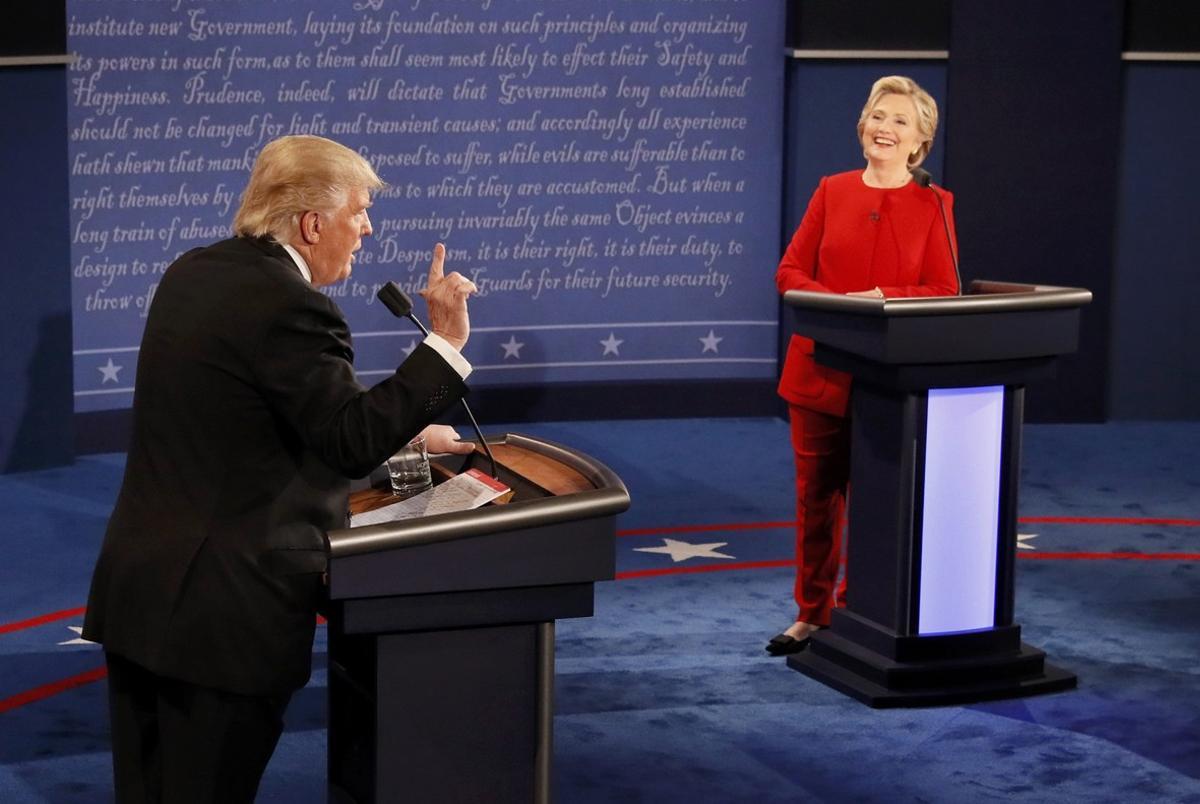 Republican U.S. presidential nominee Donald Trump speaks as Democratic U.S. presidential nominee Hillary Clinton listens during their first presidential debate at Hofstra University in Hempstead, New York, U.S., September 26, 2016.              REUTERS/Rick Wilking