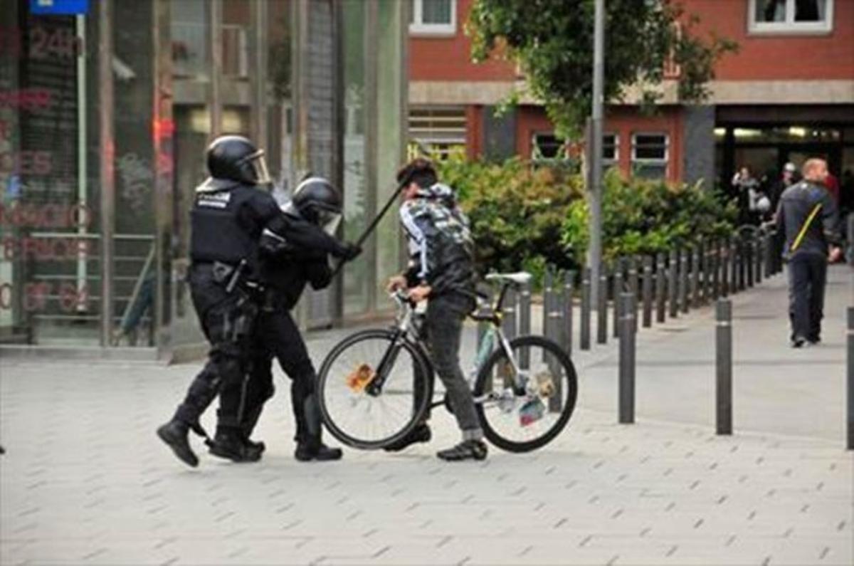 Imatge en què es veu un mosso donant un cop amb la porra al cap al noi denunciant. Imatge en què es veu un mosso donant un cop amb la porra al cap al noi denunciant.