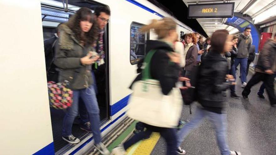 Usuarios bajan de un vagón del metro madrileño, que ayer se vio afectado por un acto de protesta contra la subida de tarifas.