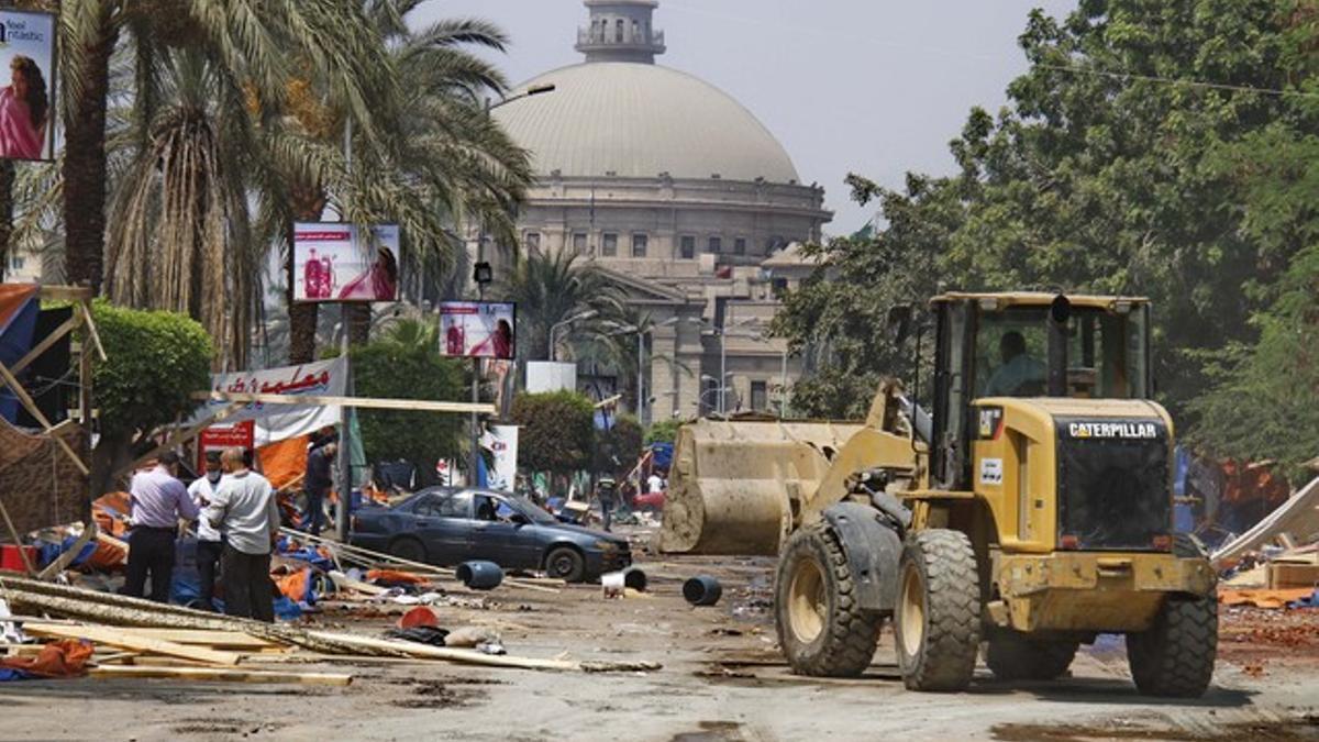 Un bulldózer retira escombros de una plaza donde estaban acampados seguidores del depuesto Mursi.