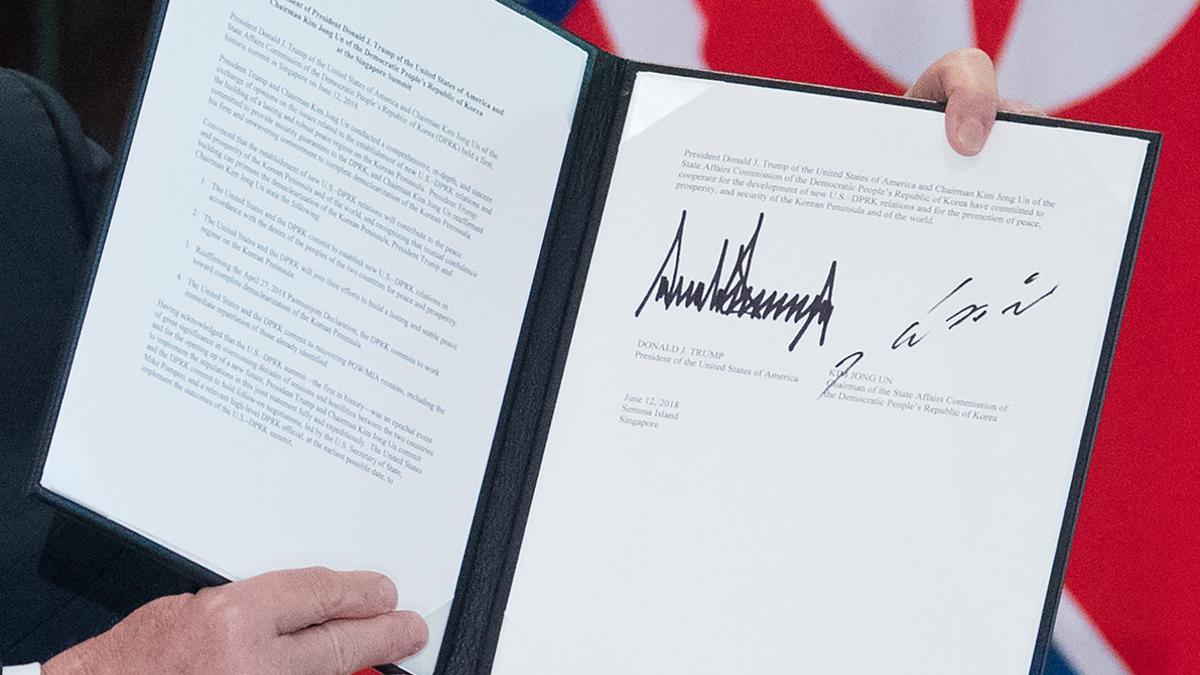 Trump muestra la declaración conjunta que él y Kim Jong-un han firmado en Singapur.