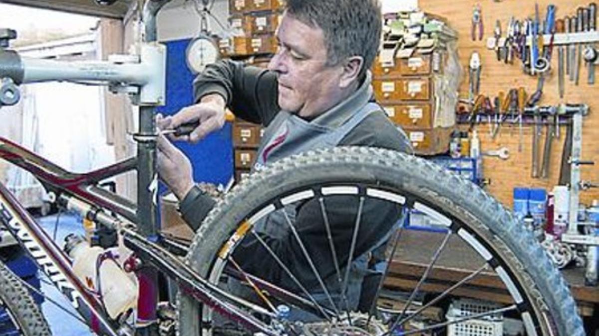 Mecánico repara una bicicleta en su taller