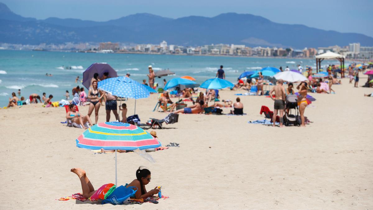 People sunbathe at Playa De Palma beach, as Spain prepares to officially reopen its borders, in Palma de Mallorca, Spain June 14, 2020.