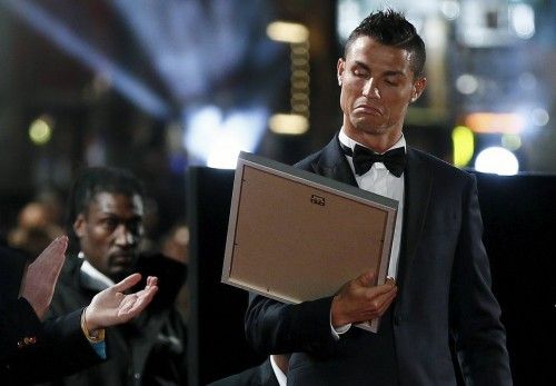 Soccer player Ronaldo reacts as he receives a certificate on the red carpet at the world premiere of "Ronaldo" at Leicester Square in London