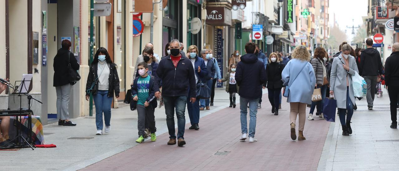 Imagen de archivo de personas paseando por el centro de Castelló con mascarilla.