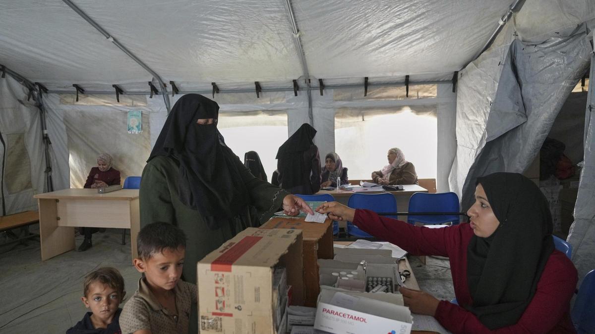 Una mujer recibe medicinas en un campo de desplazados de Yan Junis, en Gaza.