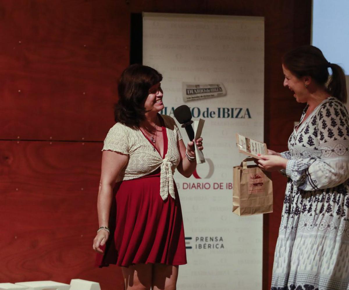 Joaquín García recibe de Estela Armanda un bono para que uno de sus hijos disfrute con tres talleres de cocina para niños en Tierra de Ibiza.