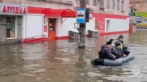 Rescuers evacuate residents from a flood zone in Orsk