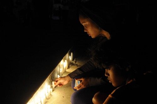 Dominican supporters of Venezuela's President Hugo Chavez light candles in Santo Domingo