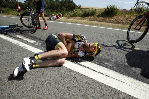 Lotto-Jumbo rider Laurens ten Dam of the Netherlands lies on the ground after a fall during the third stage of the 102nd Tour de France cycling race from Anvers to Huy