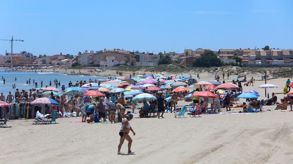 Llenazo de sombrillas y toallas en una playa del litoral de Cartagena, este sábado.