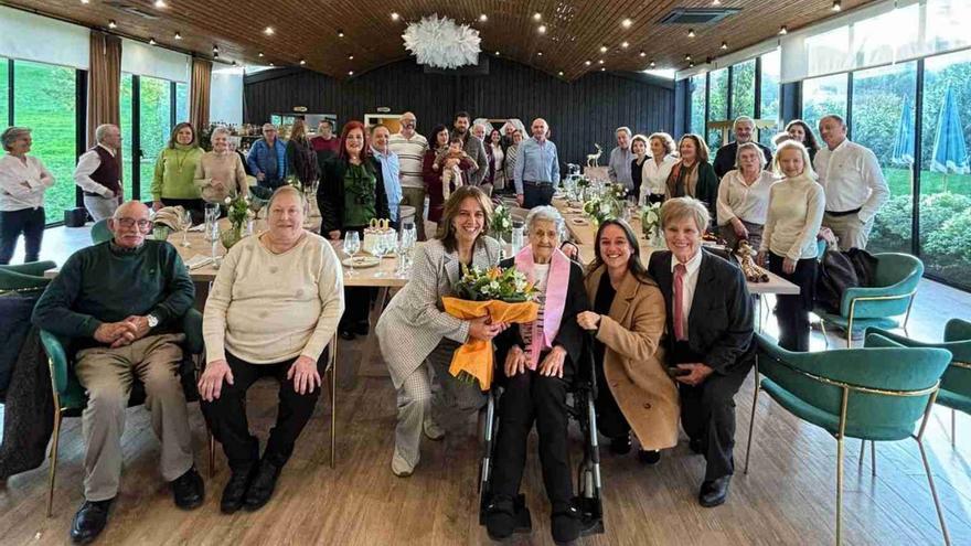 Maruja recibe el ramo de flores de manos de Pena y Troitiño durante la celebración familiar.