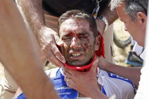 FDJ rider William Bonnet of France receives medical help as he sits on the ground after a fall during the third stage of the 102nd Tour de France cycling race from Anvers to Huy