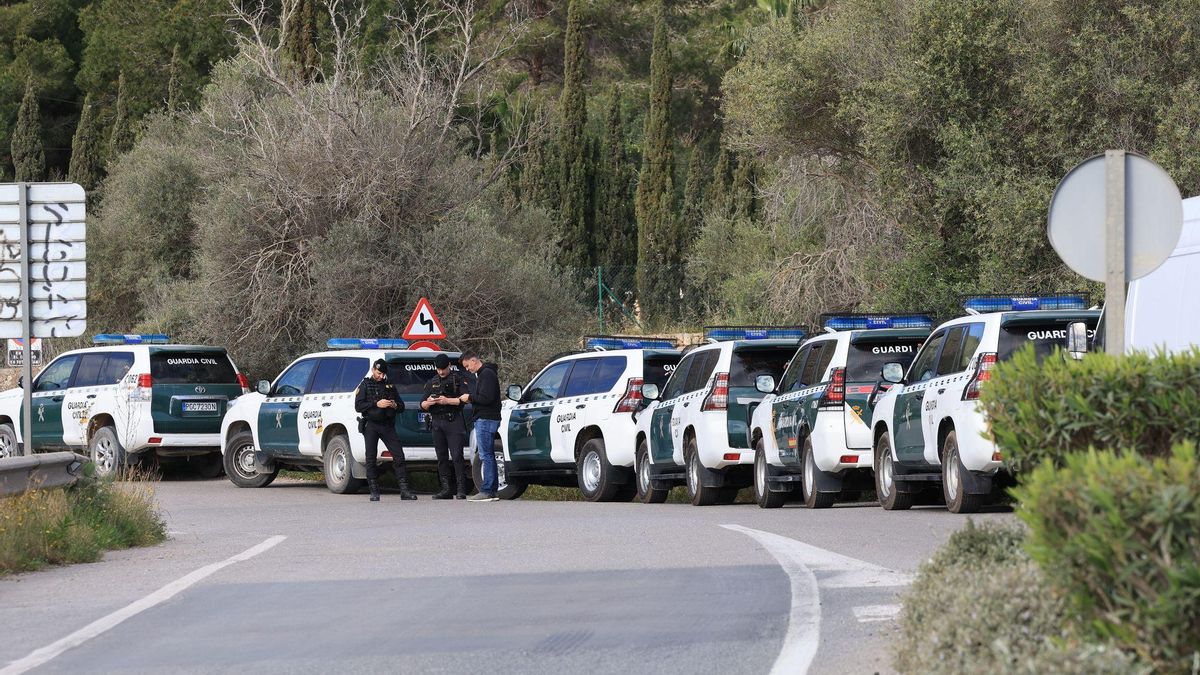Vehículos de la Guardia Civil en la carretera junto al asentamiento