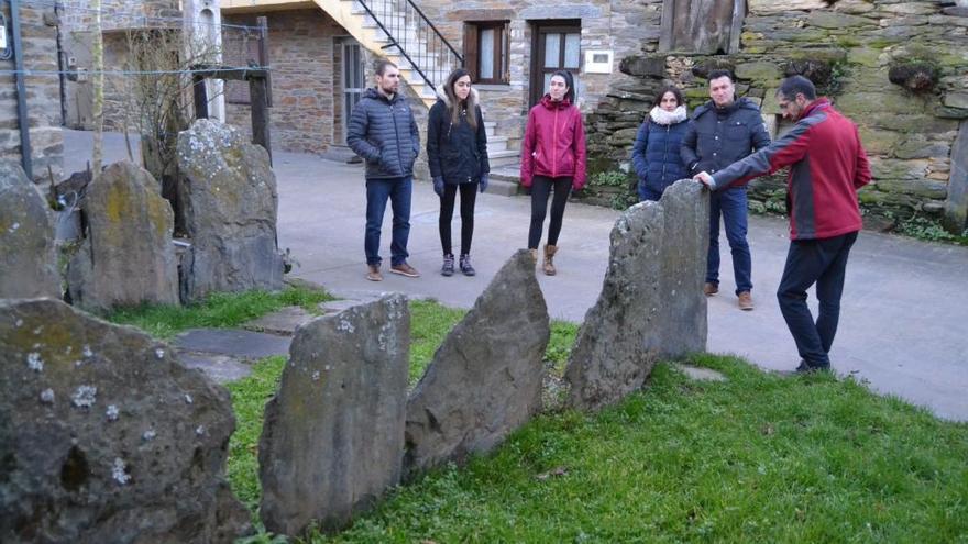 Un grupo de jóvenes ante una valla de grandes lascas en Robledo.