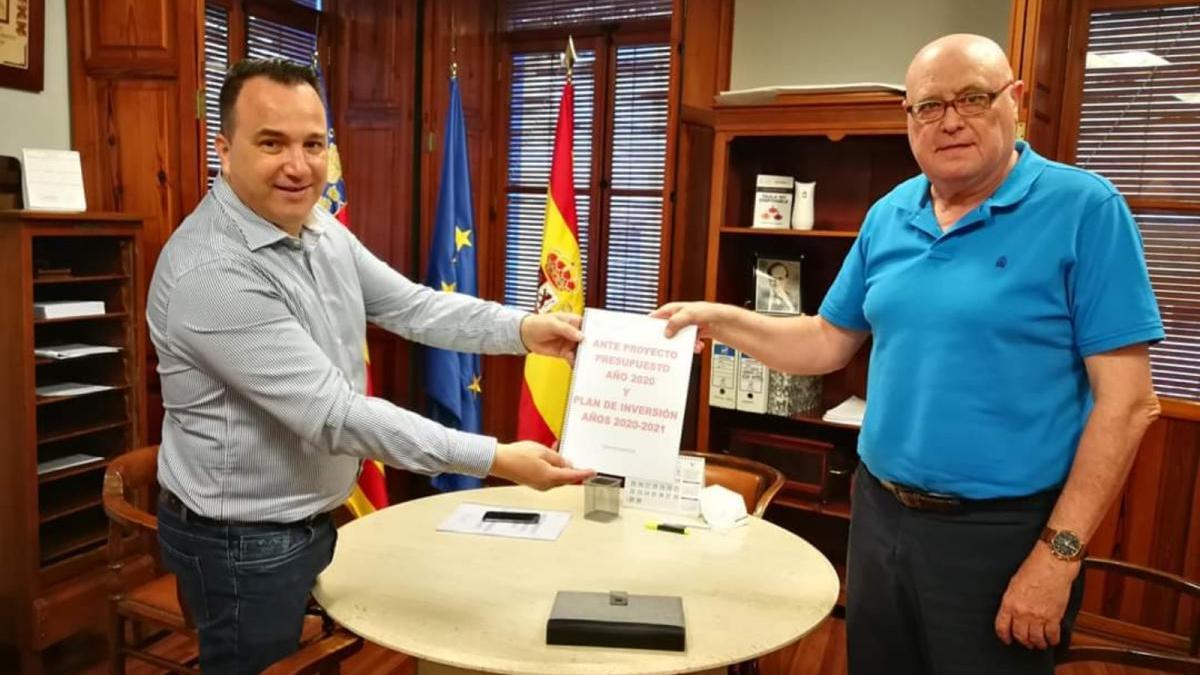 El alcalde de Sollana, a la izquierda, muestra el proyecto de presupuesto.