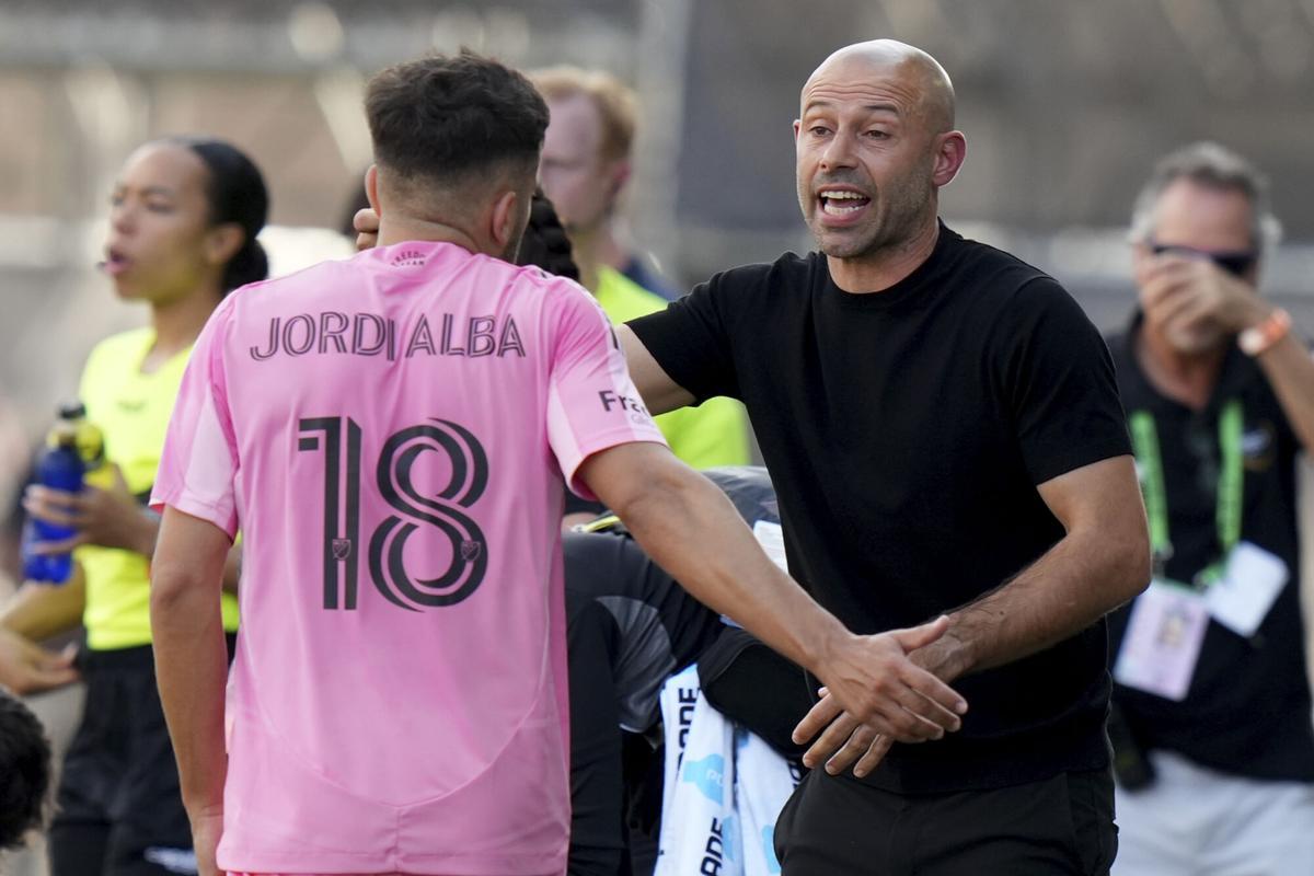 Inter Miami head coach Javier Mascherano, right, talks with defender Jordi Alba (18) during the first half of an MLS soccer match against Charlotte FC, Sunday, March 9, 2025, in Fort Lauderdale, Fla. (AP Photo/Lynne Sladky)